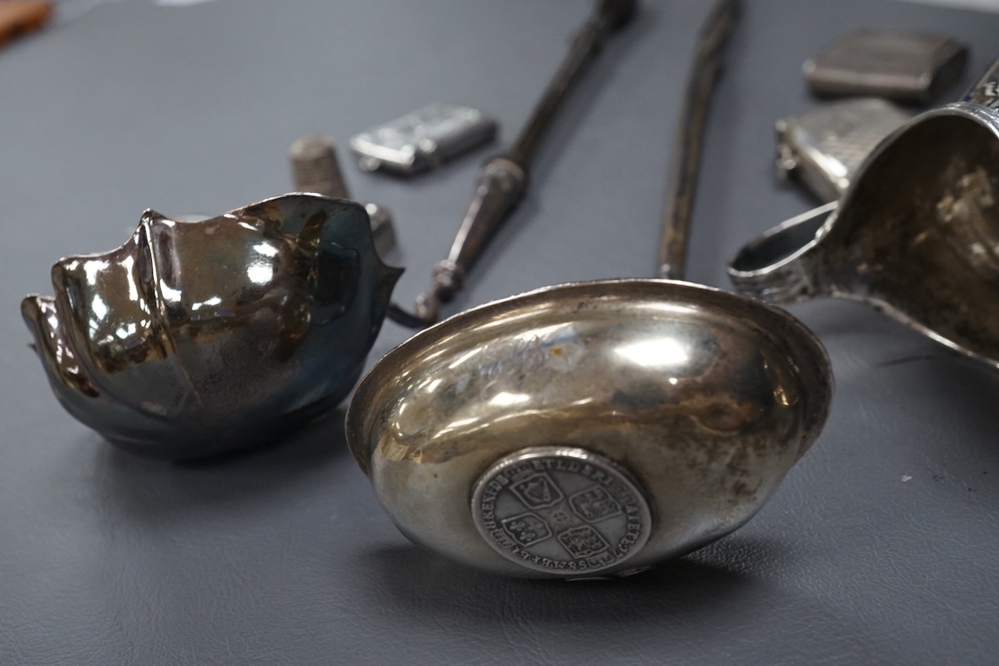 A small group of collectable silver including a George III silver cream jug, London, 1804, height 95mm, three silver vesta cases, two pill boxes, an envelope stamp case, two Georgian toddy ladles, one unmarked, together